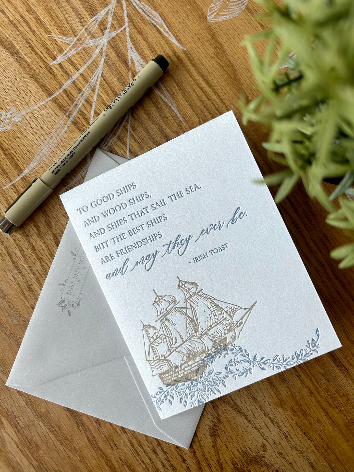 Style shot of letterpress friendship card with florals and a ship that reads " 'To good ships and wood ships, and ships that sail the sea, but the best ships are friendships and may they ever be.- Irish toast'" by Rust Belt Love