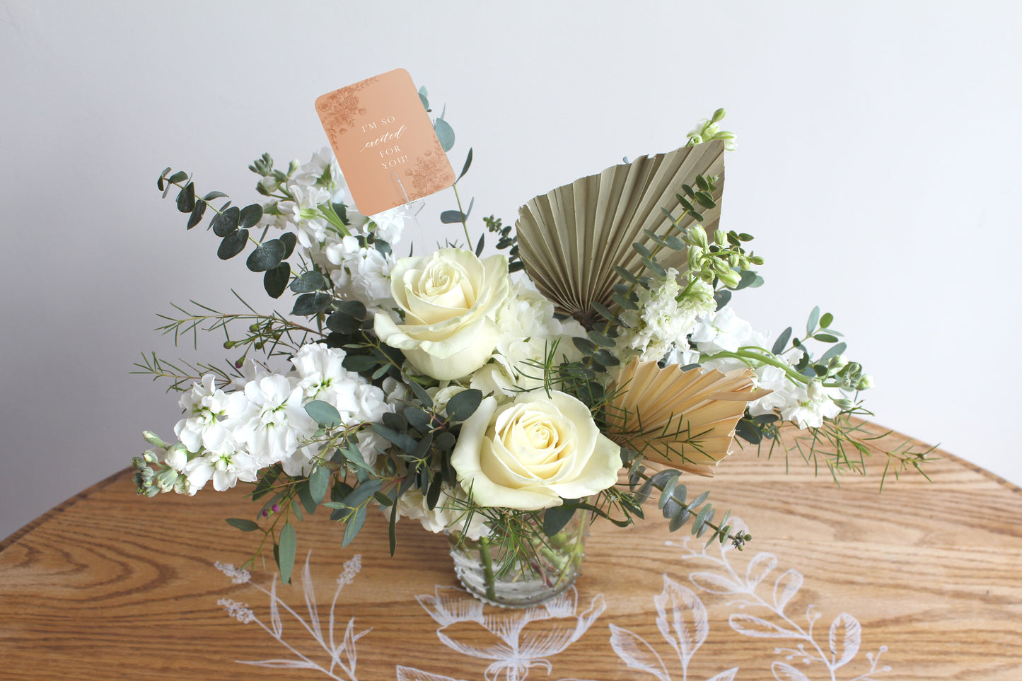 Styleshot of Rust Belt Love's orange floral minicard in a bouquet of flowers
