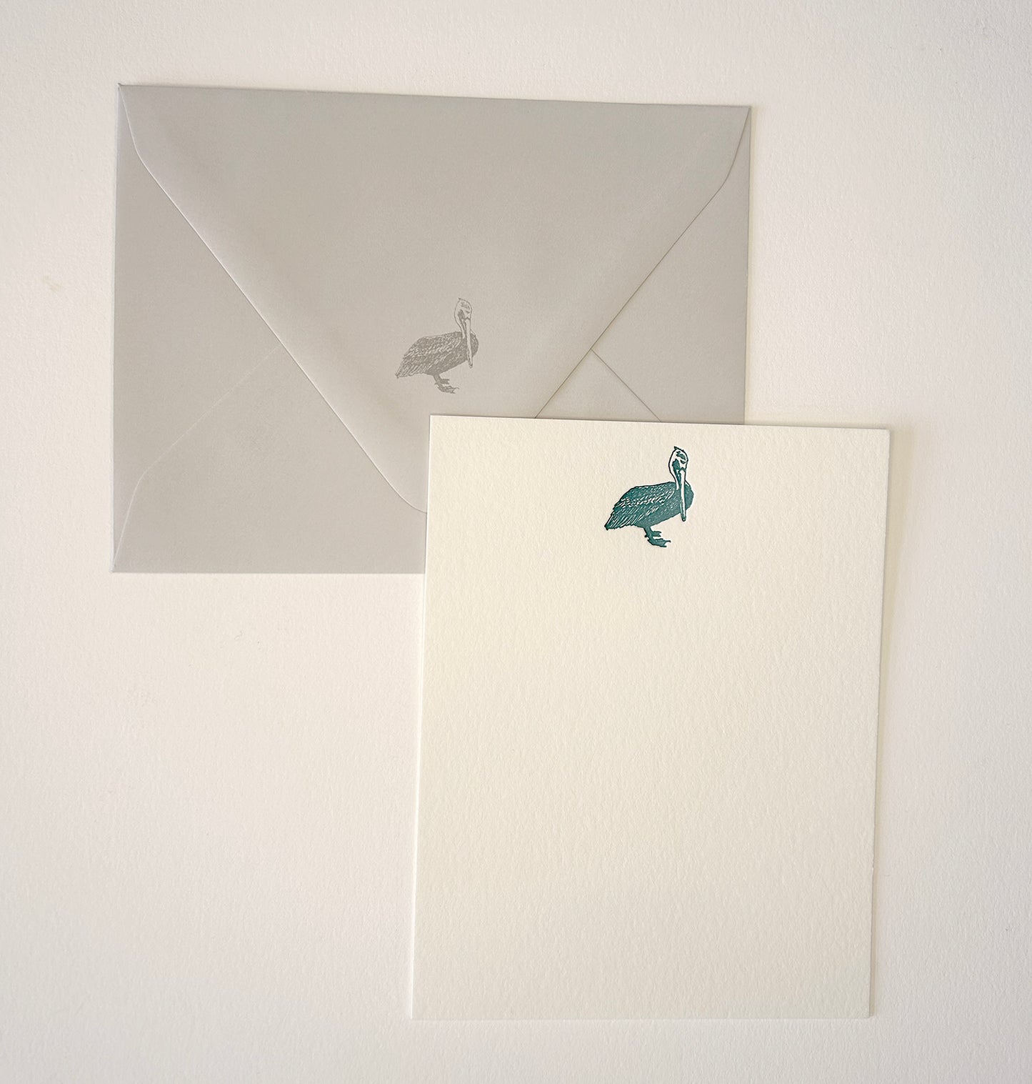 Letterpress flat note card with a teal pelican by Rust Belt Love