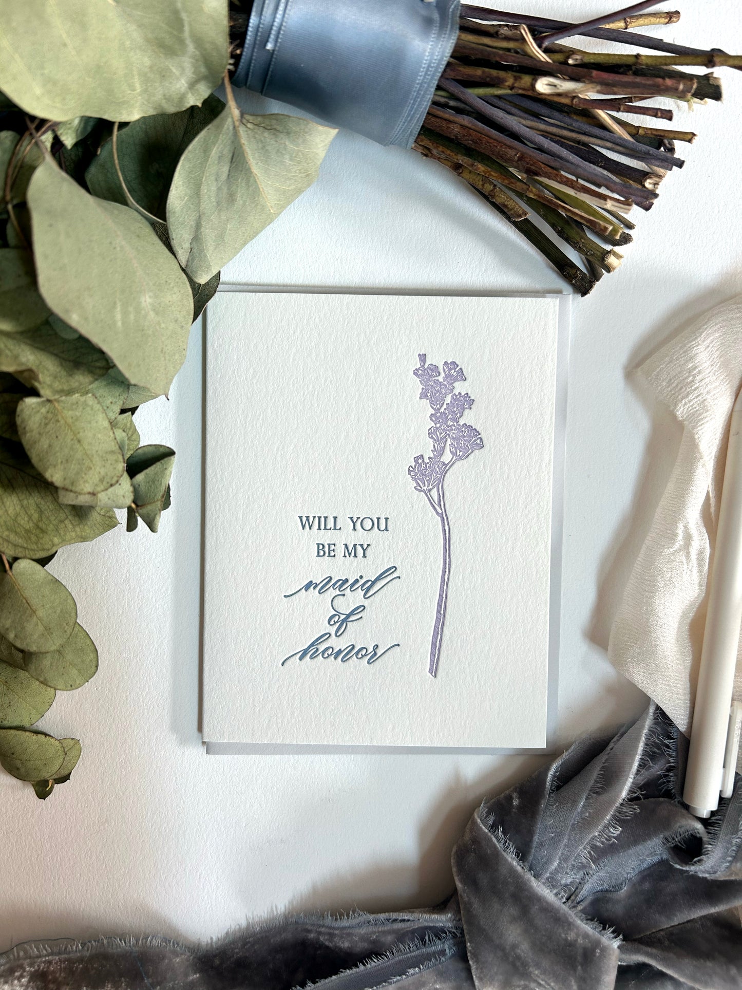 Style shot of letterpress floral wedding card by Rust Belt Love that reads "Will you be my maid of honor"