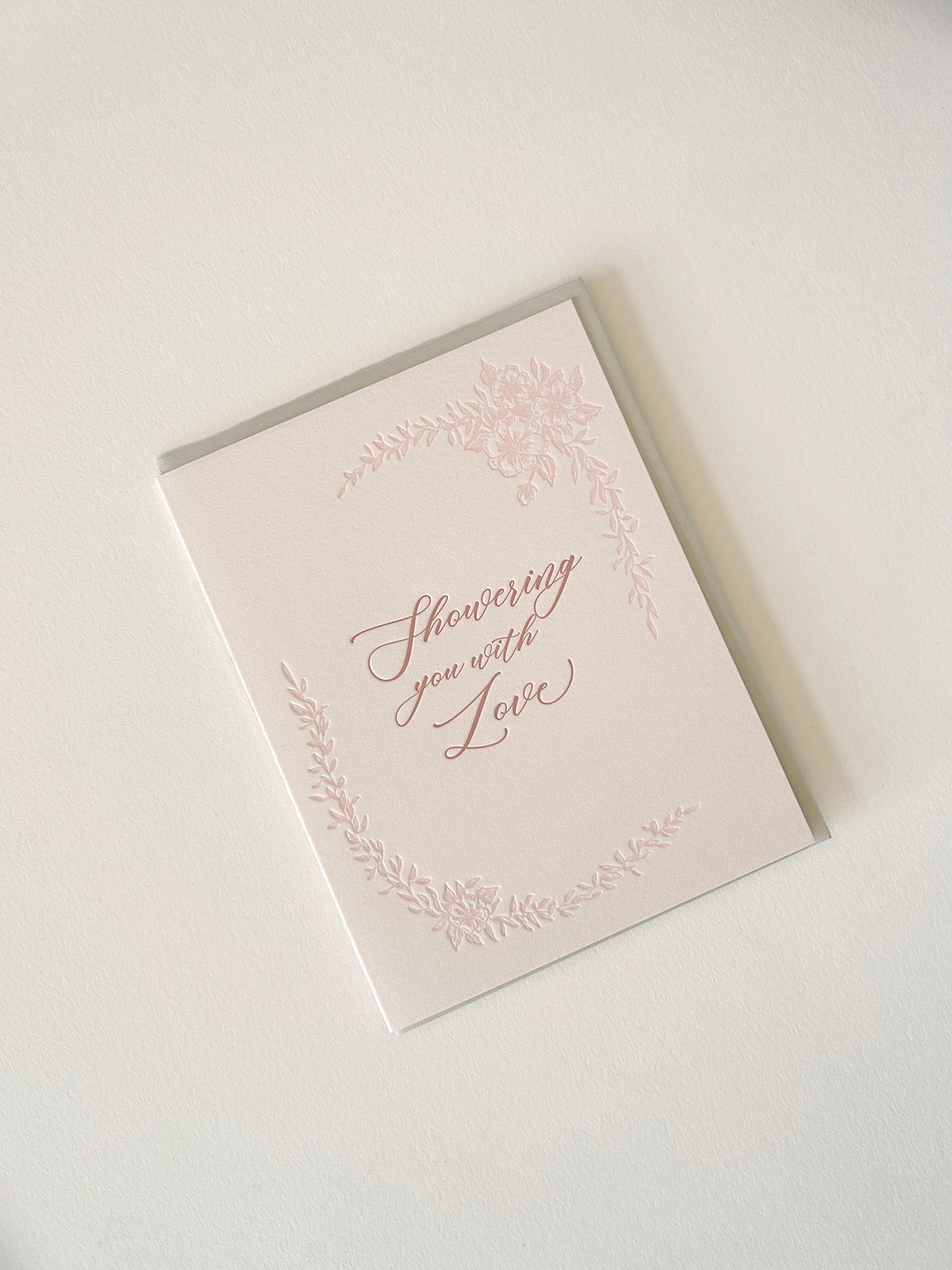 Letterpress love card with florals that says "Showering you with love" by Rust Belt Love