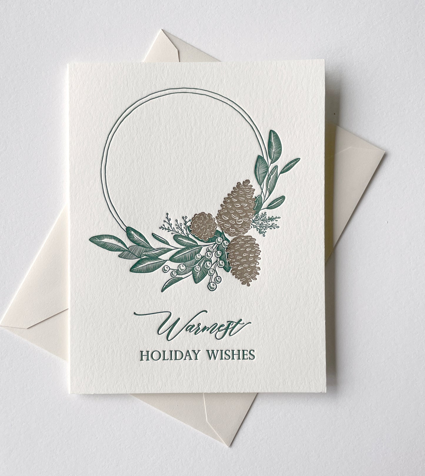 Letterpress holiday card with pinecones and greenery that says "Warmest holiday wishes" by Rust Belt Love