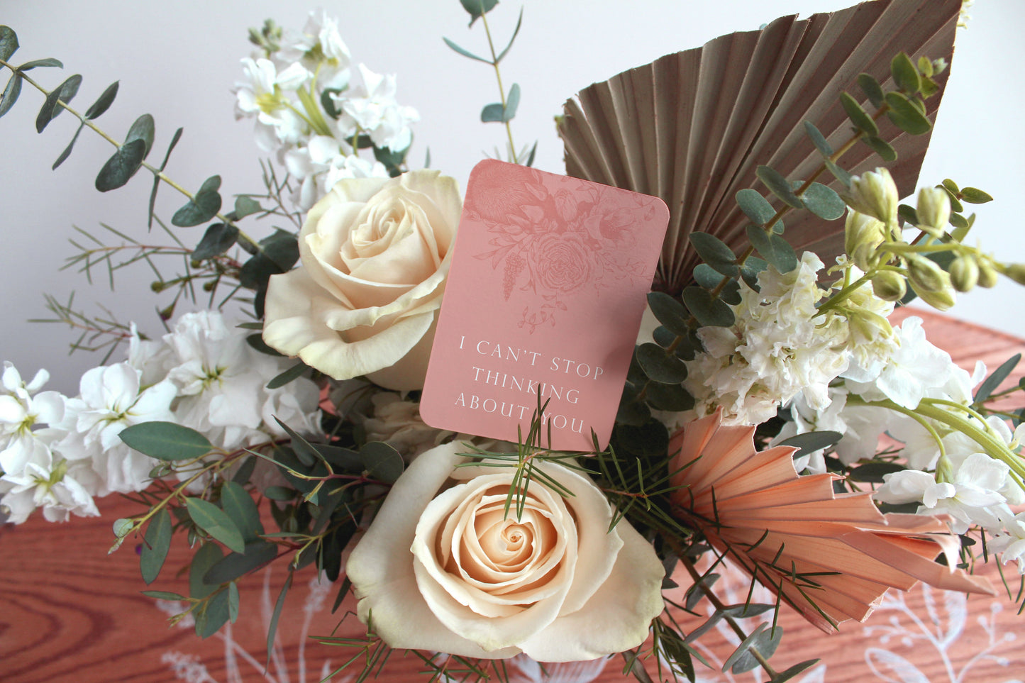 A style shot of "I can't stop thinking about you" minicard in a bouquet of flowers