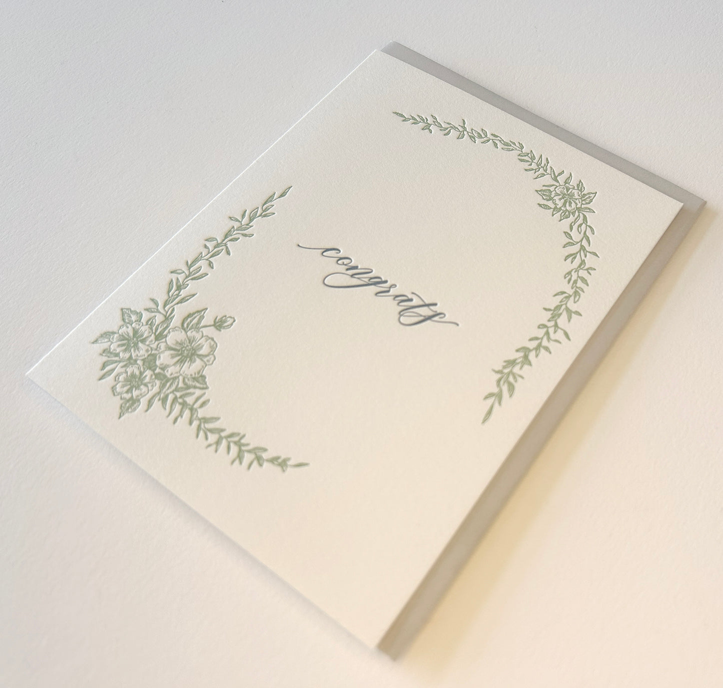 Letterpress congrats card with greenery that says "Congrats" in the middle by Rust Belt Love