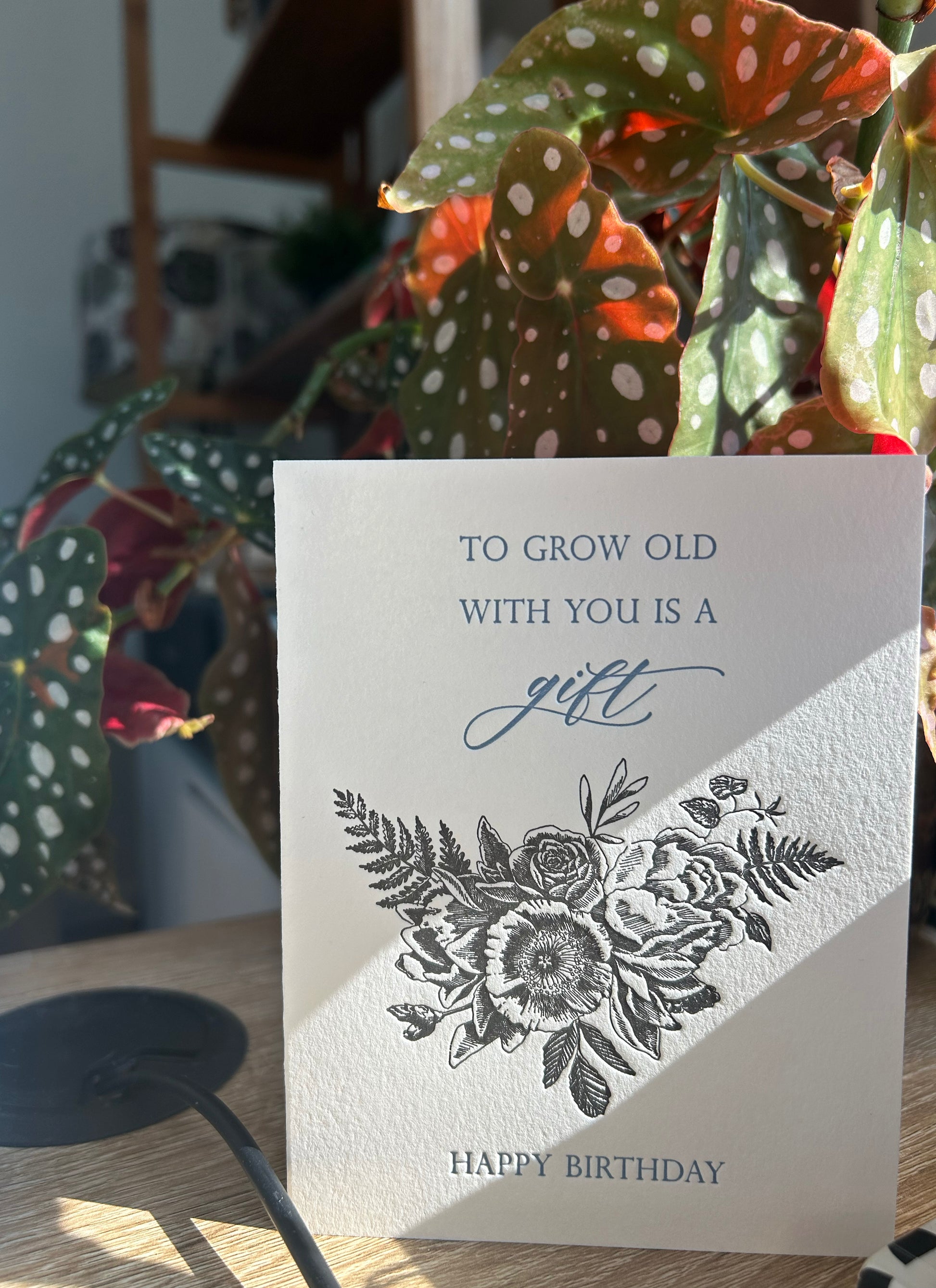 Style shot of letterpress birthday card with black florals that reads "To grow old with you is a gift happy birthday" by Rust Belt Love