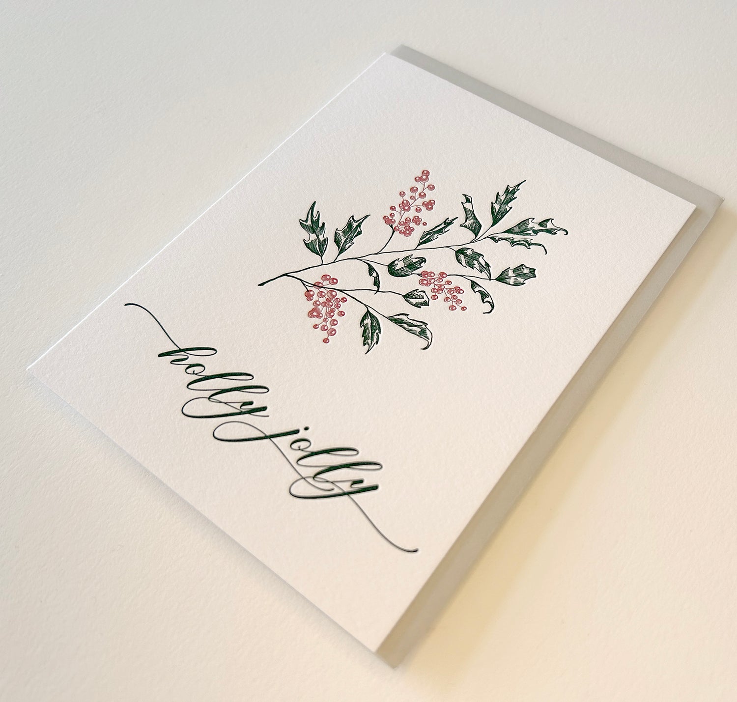 Letterpress holiday card with holly that says "holly jolly" by Rust Belt Love