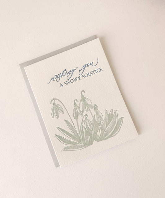 Letterpress holiday card with snowdrop flowers that says "Wishing You A Snowy Solstice" by Rust Belt Love