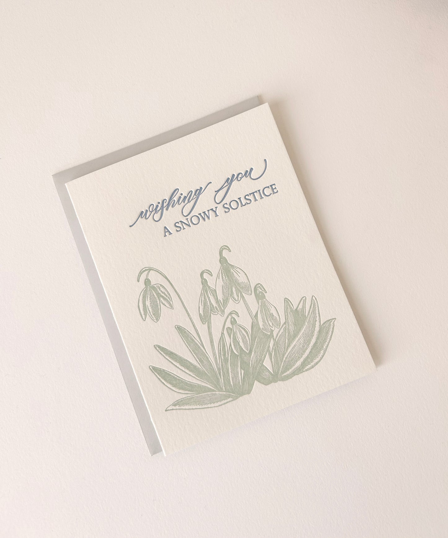 Letterpress holiday card with snowdrop flowers that says "Wishing You A Snowy Solstice" by Rust Belt Love
