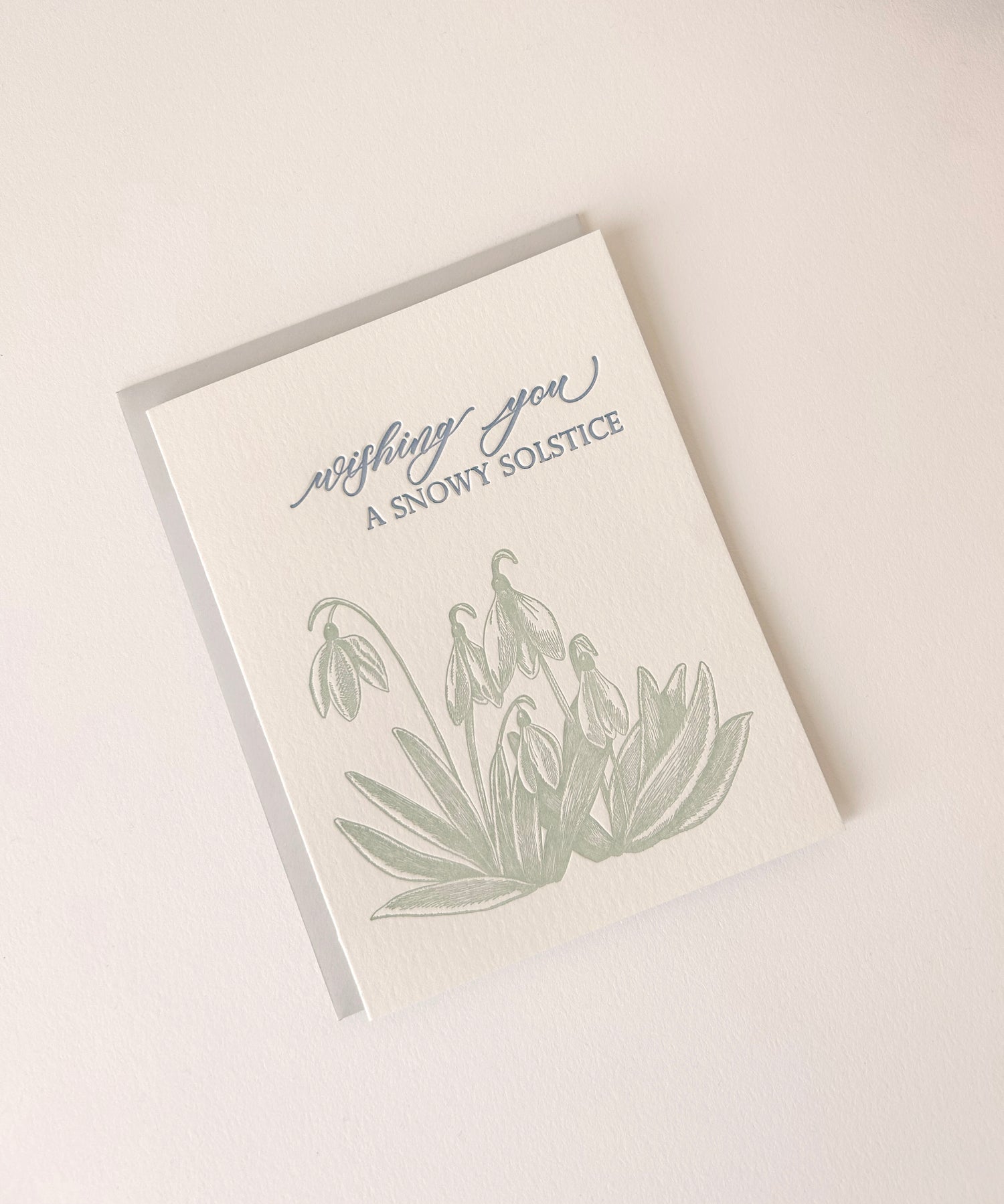 Letterpress holiday card with snowdrop flowers that says "Wishing You A Snowy Solstice" by Rust Belt Love