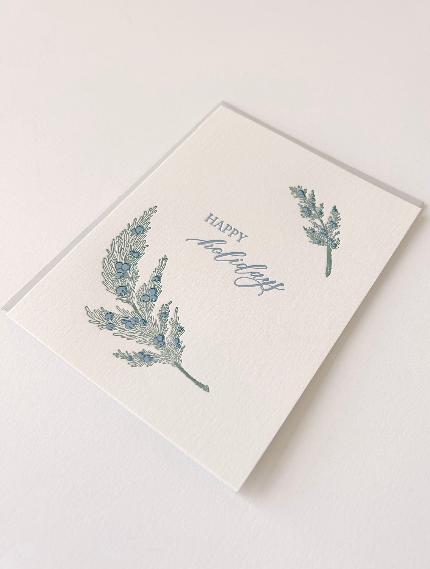 Letterpress holiday card with greenery that says "Happy Holidays" by Rust Belt Love