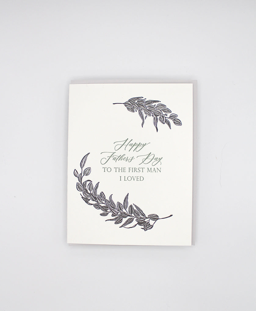 Letterpress father's day card with black greenery that reads "Happy Father's Day to the first man I loved"by Rust Belt Love