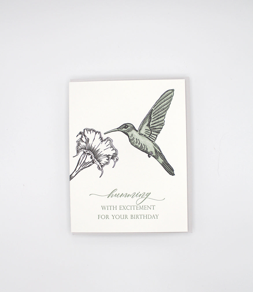 Letterpress birthday card with a flower and hummingbird that reads "Humming with excitement for your birthday" by Rust Belt Love