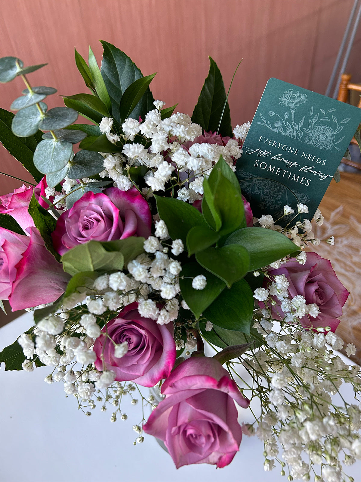 Styleshot of Rust Belt Love's green floral minicard in a bouquet of flowers