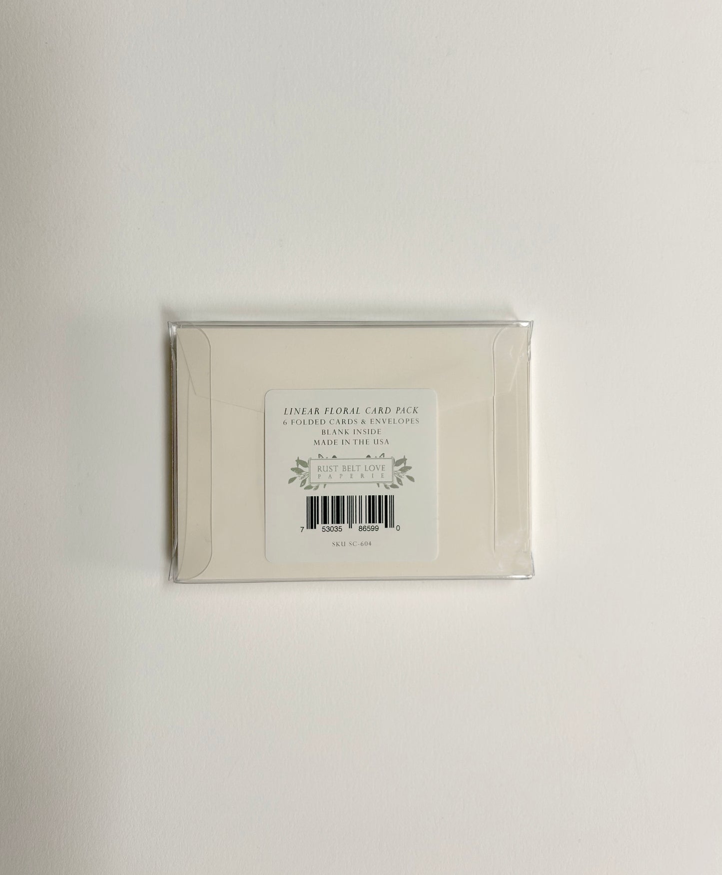 Back of clear box packaging for Rust Belt Love's small note card