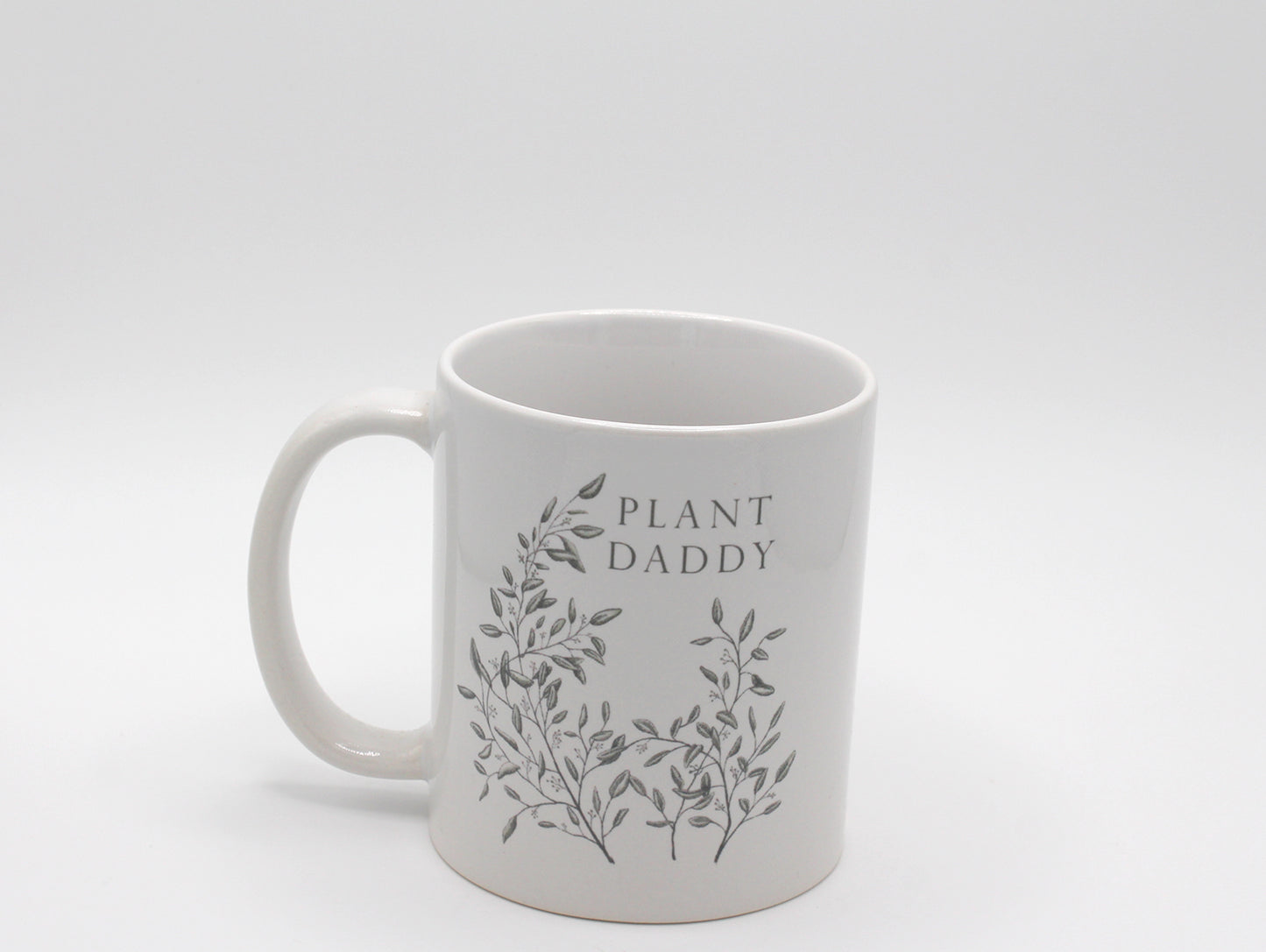 White ceramic mug with greenery that says "Plant daddy" by Rust Belt Love