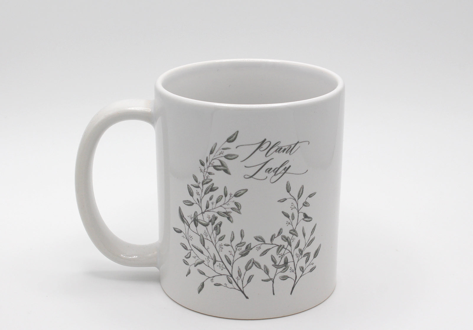 White ceramic mug with drawing of leafy greenery and words "Plant Lady" by Rust Belt Love