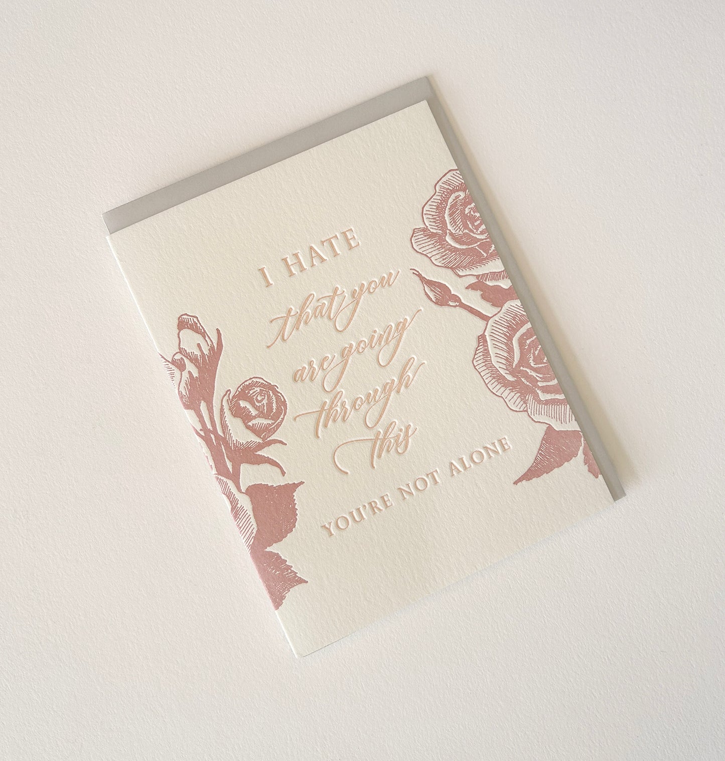 Letterpress sympathy card with florals that says "I hate that you are going through this, you're not alone" by Rust Belt Love