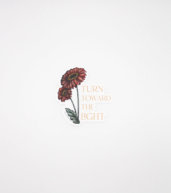 Floral sticker by Rust Belt Love that reads "turn towards the light"