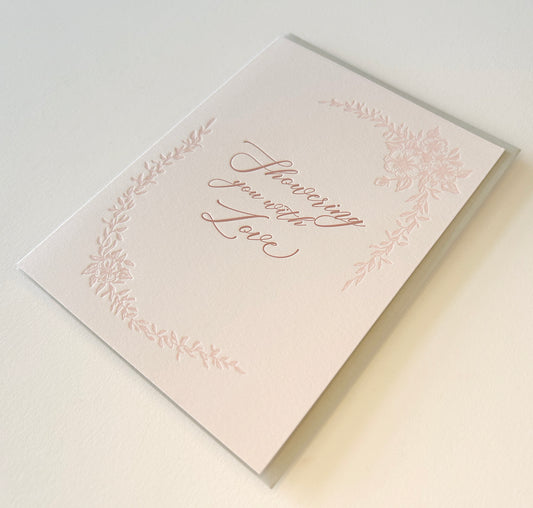 Letterpress love card with florals that says "Showering you with love" by Rust Belt Love