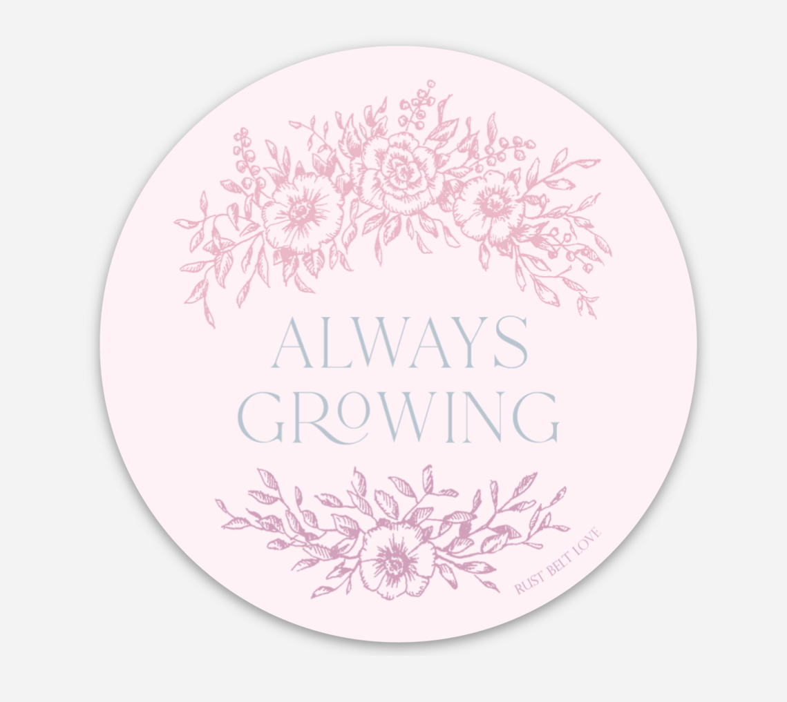Circular pink sticker with florals that says "always growing" by Rust Belt Love