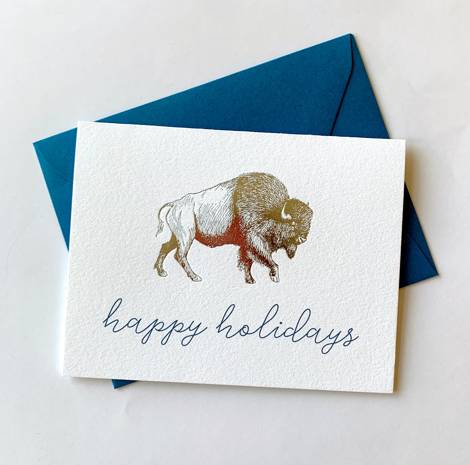 Letterpress card with silver foil buffalo that says " Happy holidays" by Rust Belt Love