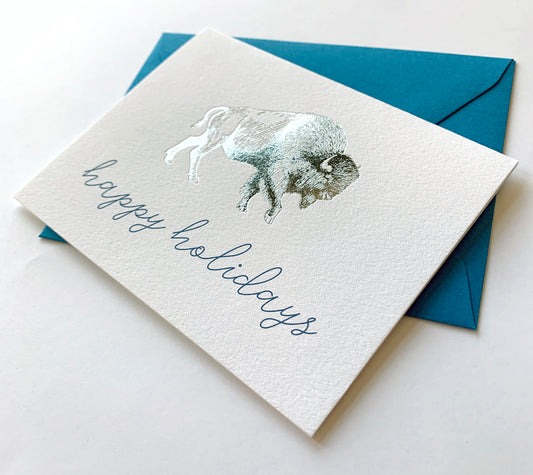 Letterpress card with silver foil buffalo that says " Happy holidays" by Rust Belt Love