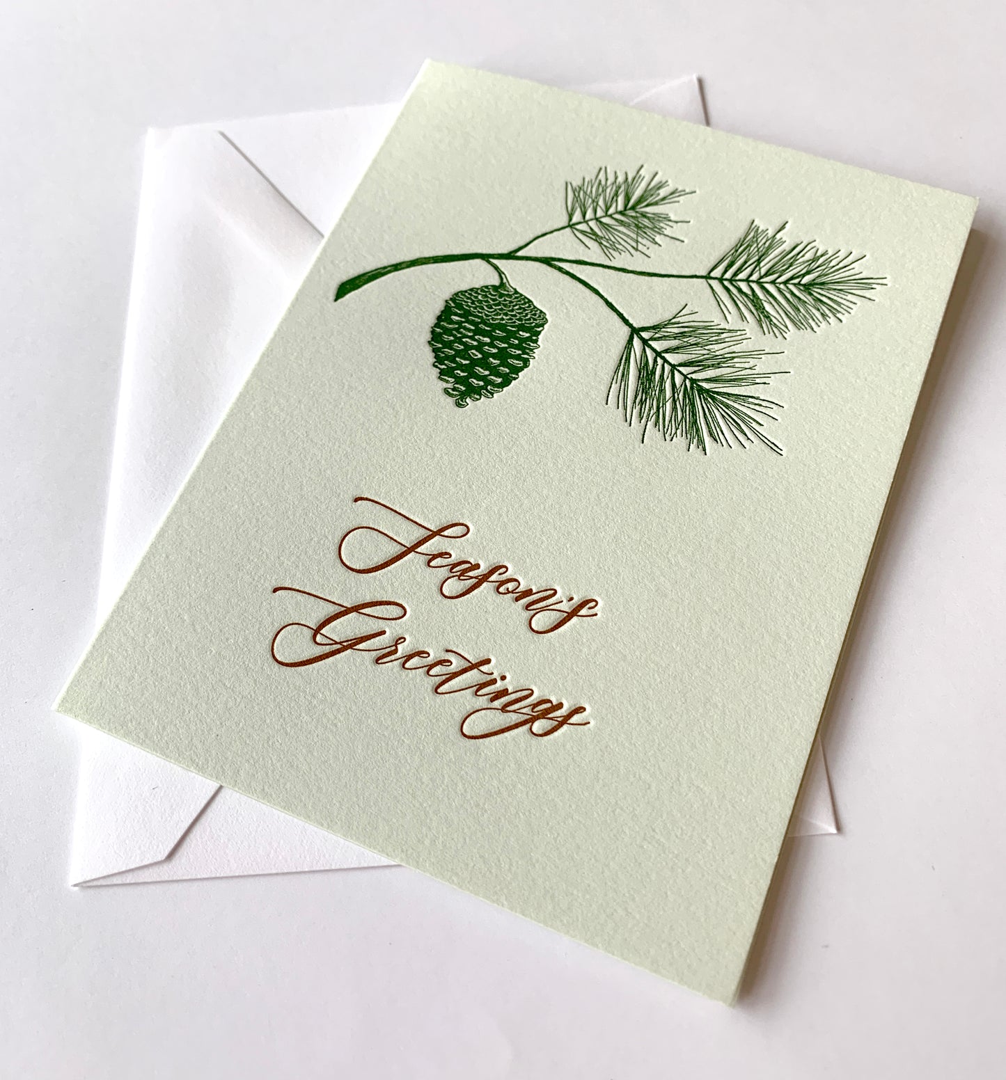 Letterpress holiday card with pinecone that says "Season's greetings" by Rust Belt Love