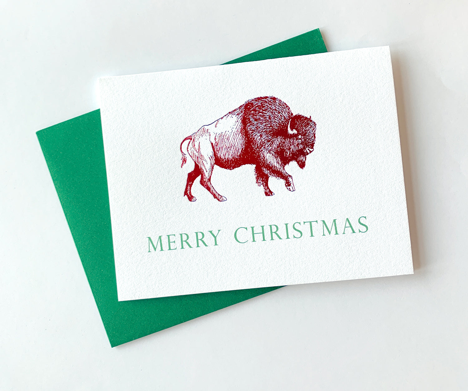 Letterpress holiday card with red foil buffalo that says "Merry Christmas" by Rust Belt Love