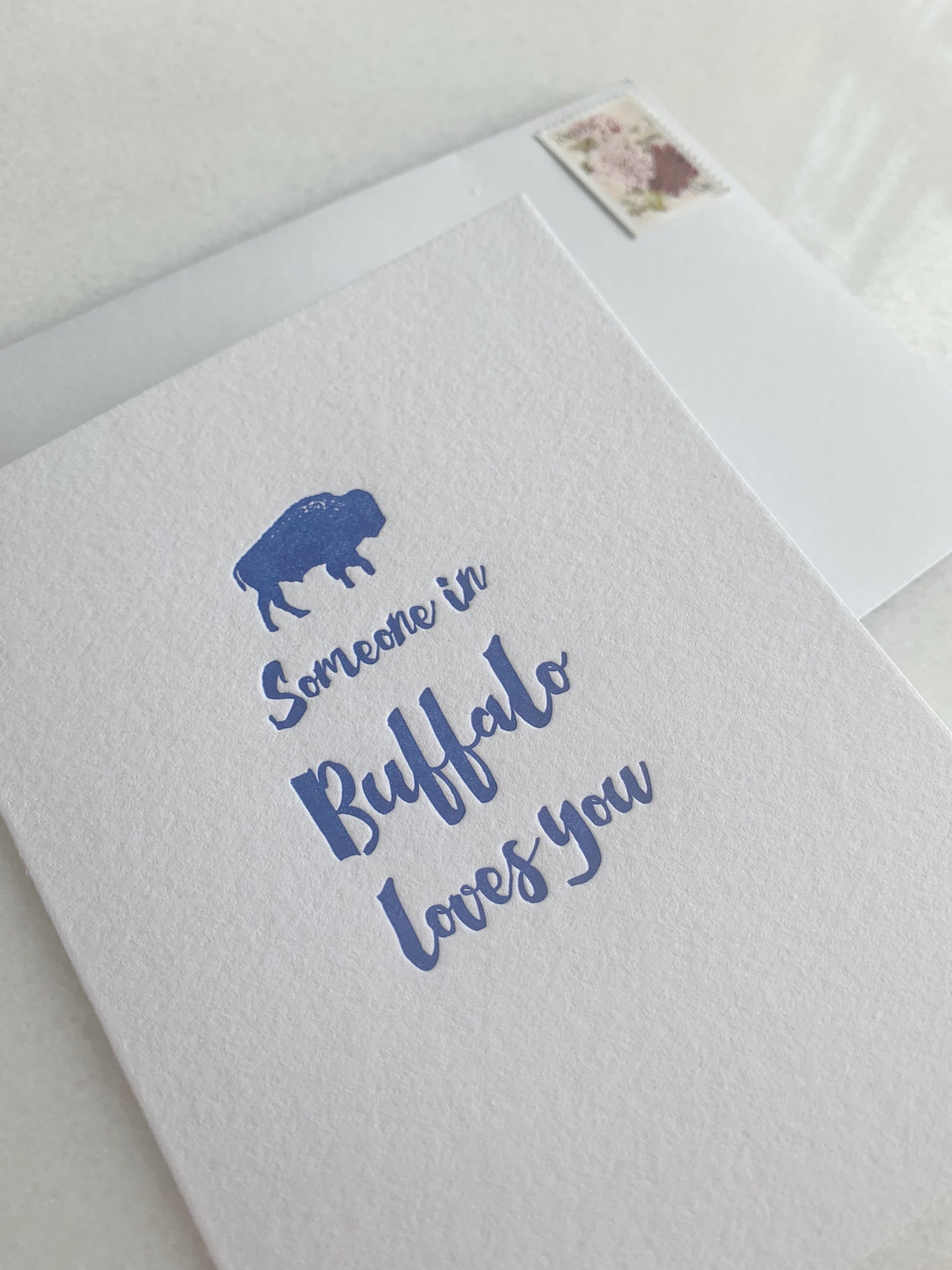 Letterpress  card with tiny blue buffalo that says "Someone in Buffalo loves you" by Rust Belt Love