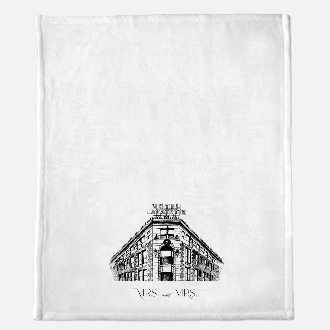 White minky blanket with Hotel Lafayette illustration that says "Mrs. and Mrs." by Rust Belt Love