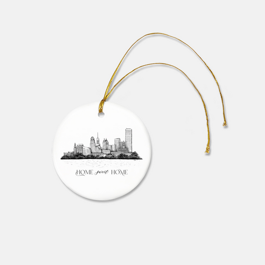 Round frosted glass ornament with the buffalo skyline on it that says "home sweet home" with a gold ribbon by Rust Belt Love