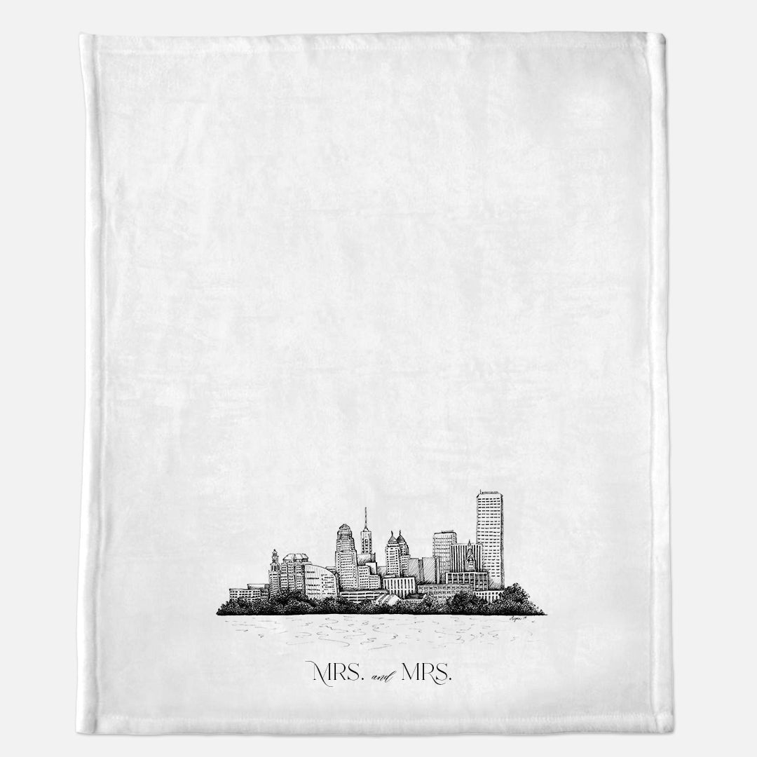 White minky blanket with Buffalo Skyline illustration that says "Mrs. and Mrs." by Rust Belt Love