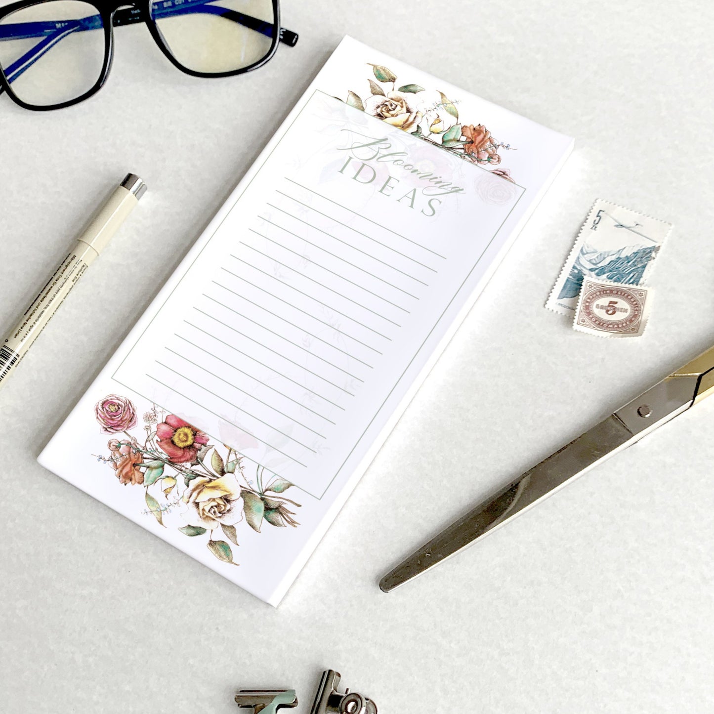 3.5 by 8.5 notepad with lined sheets with florals that says "Blooming ideas" by Rust Belt Love