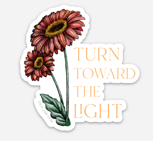 Floral sticker by Rust Belt Love that reads "turn towards the light"